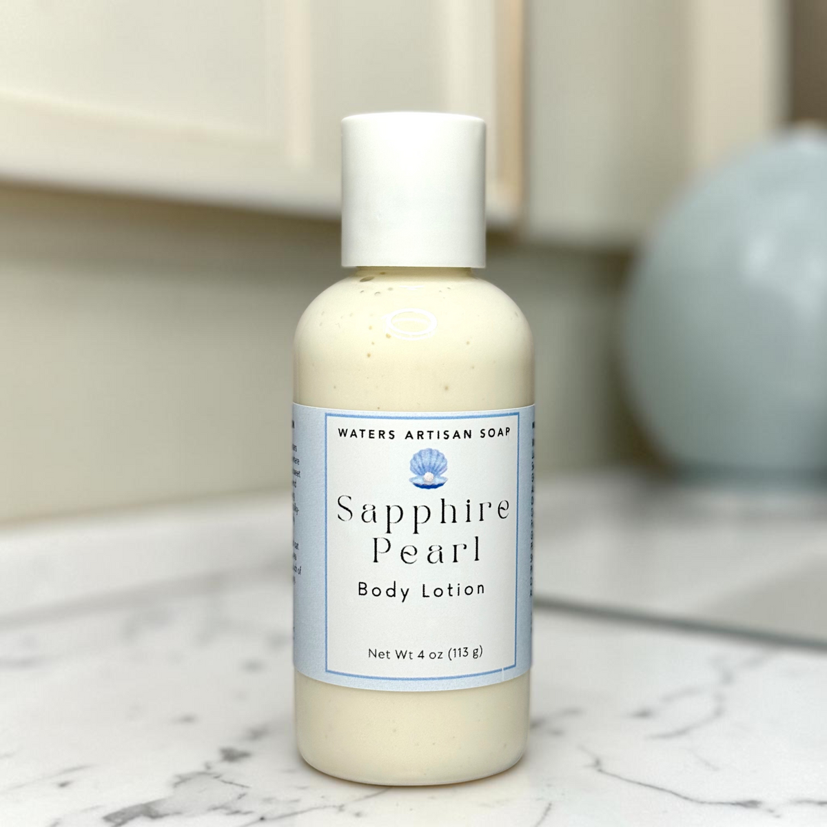 Shea Butter Body Lotion Vegan Handmade Moisturizer Aloe Vera Formula Four Ounce Clear Bottle White Flip Cap Pale Blue Label Small Batch Artisan Skincare Rice Bran Oil Sweet Almond Oil Hydrolyzed Oat Protein Grapefruit Peach Coconut Water