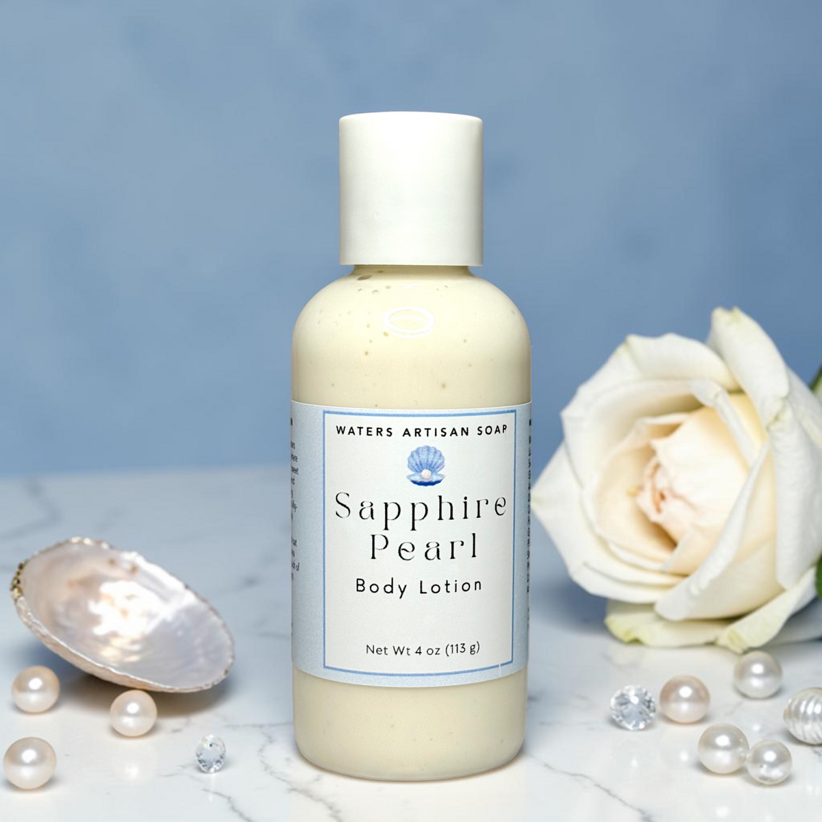 Vegan Body Lotion Handmade With Shea Butter And Aloe Vera Four Ounce Clear Bottle White Flip Top Cap Pale Blue Label Small Batch Skincare Moisturizing Formula Rice Bran Oil Sweet Almond Oil Hydrolyzed Oat Protein Grapefruit Peach Coconut